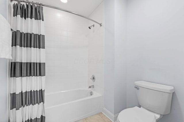 bathroom featuring tile patterned flooring, shower / bathtub combination, and toilet