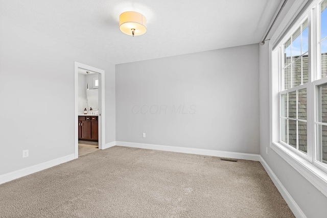 unfurnished room featuring light colored carpet