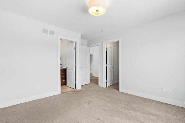 unfurnished bedroom with light colored carpet