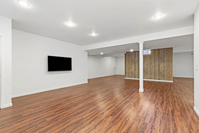 basement with dark hardwood / wood-style flooring