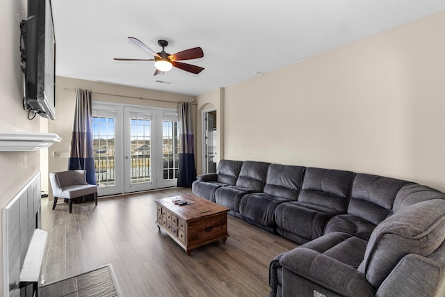 living room featuring dark hardwood / wood-style floors and ceiling fan