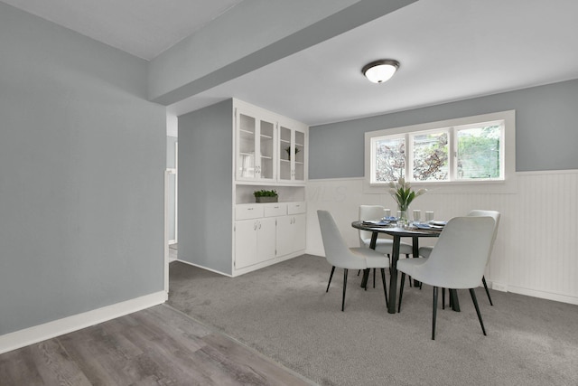 carpeted dining space with built in shelves