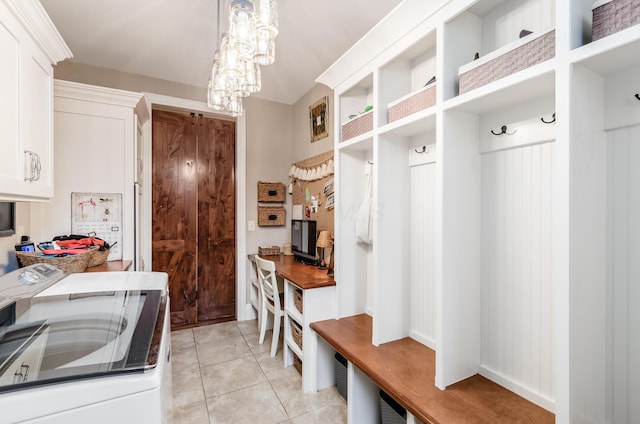 mudroom featuring light tile patterned floors and separate washer and dryer