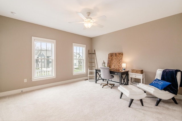 carpeted home office with ceiling fan