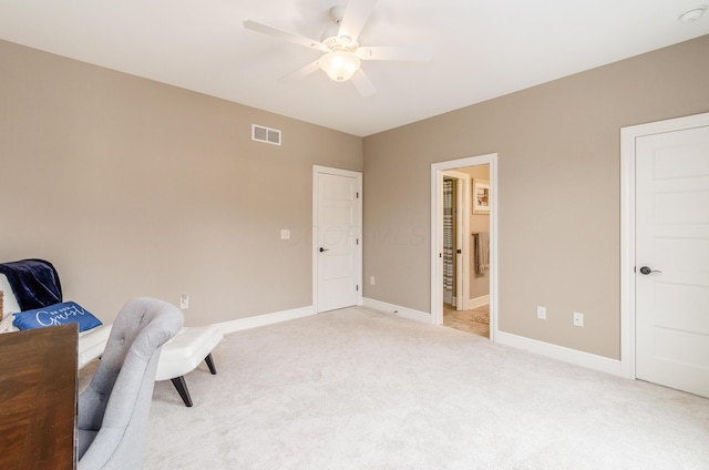 living area featuring light colored carpet and ceiling fan