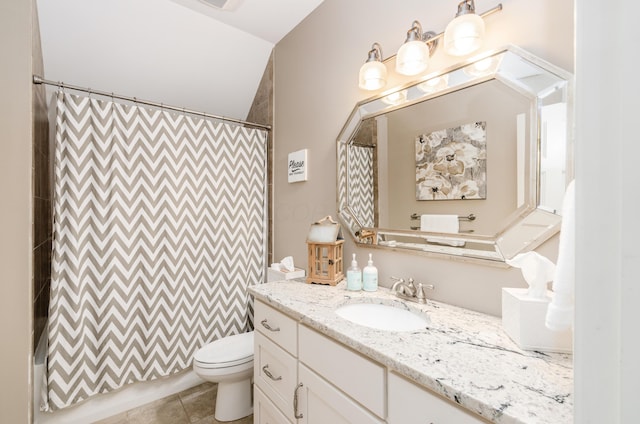 bathroom with tile patterned flooring, vanity, toilet, and vaulted ceiling