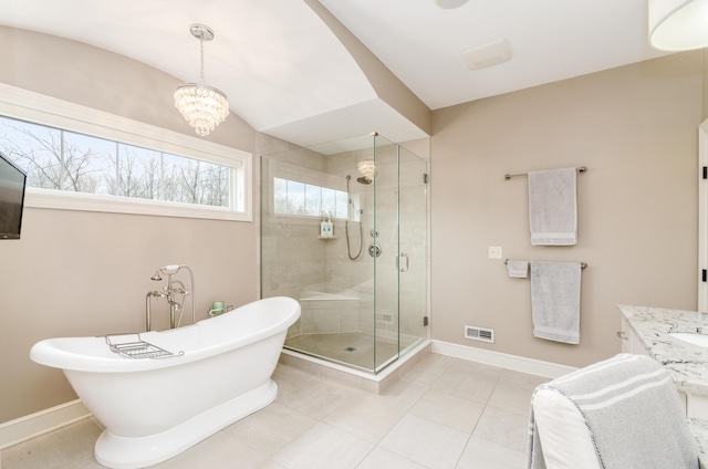 bathroom featuring tile patterned flooring, a notable chandelier, vanity, and plus walk in shower