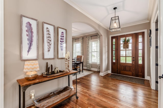 foyer entrance featuring hardwood / wood-style flooring and crown molding