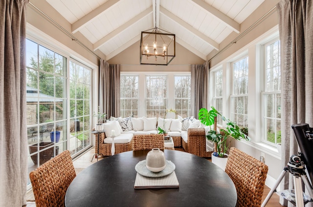 sunroom / solarium with a notable chandelier and lofted ceiling with beams