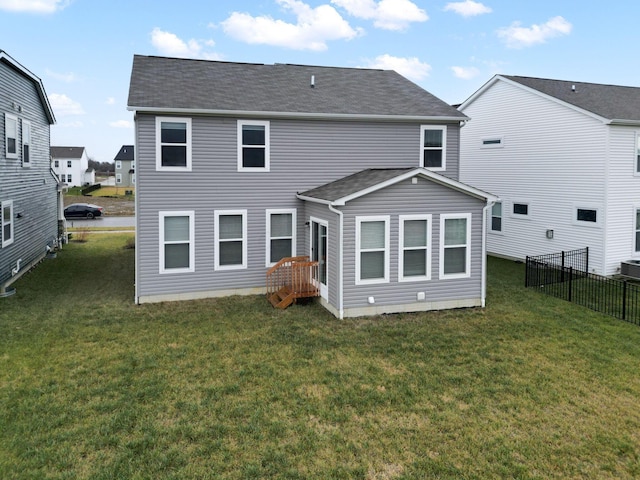 back of house with a lawn