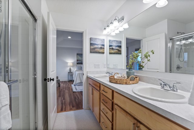 bathroom with vanity and a shower with shower door