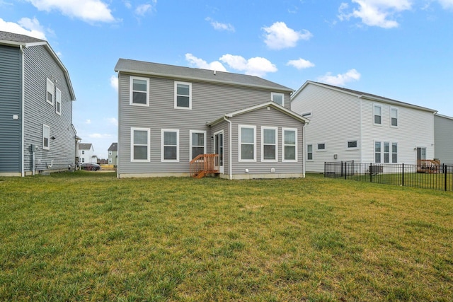 rear view of property featuring a yard