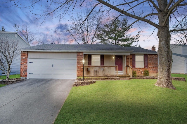 ranch-style home featuring a lawn, a porch, and a garage