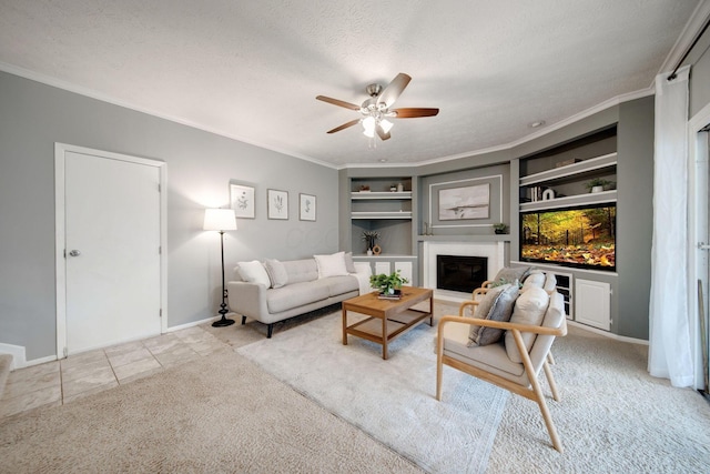 tiled living room with built in shelves, ceiling fan, crown molding, and a textured ceiling