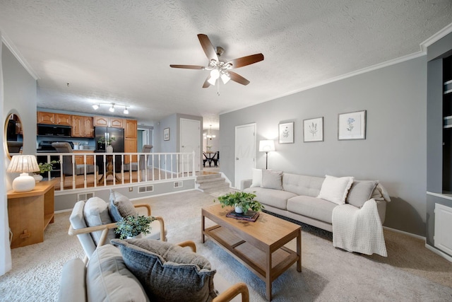 carpeted living room with ceiling fan, ornamental molding, a textured ceiling, and track lighting