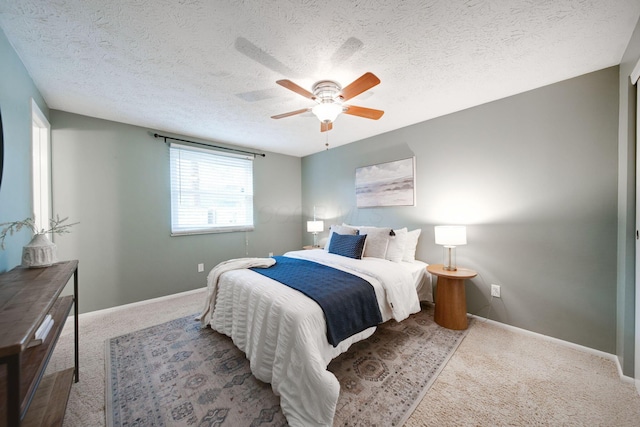 bedroom with carpet, a textured ceiling, and ceiling fan