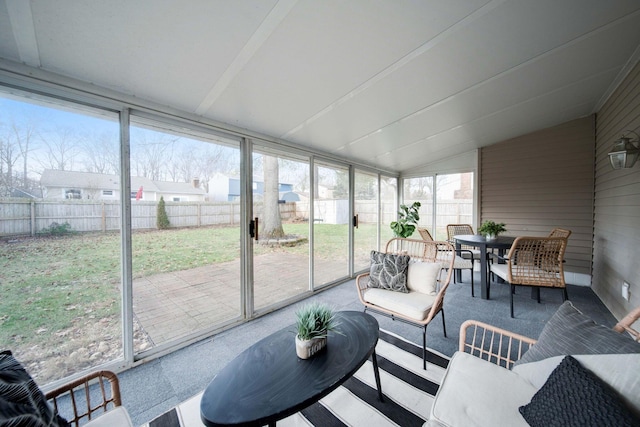 sunroom featuring a wealth of natural light and lofted ceiling