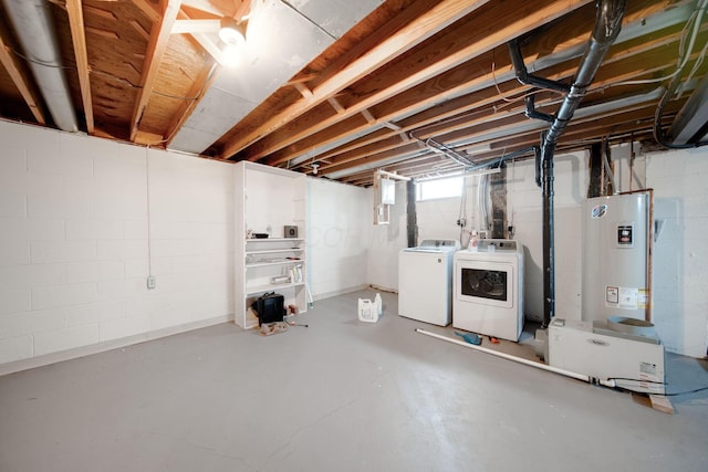 basement with washer and clothes dryer and water heater