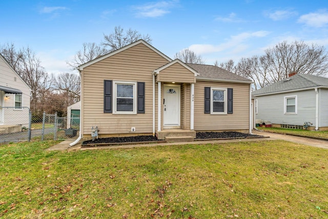 bungalow-style home featuring a front lawn