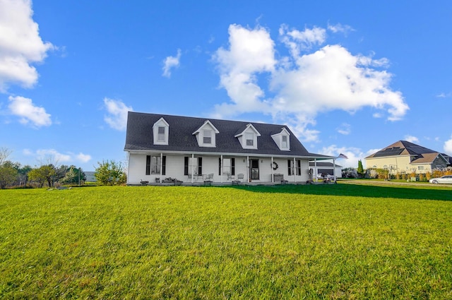 cape cod home featuring a front yard