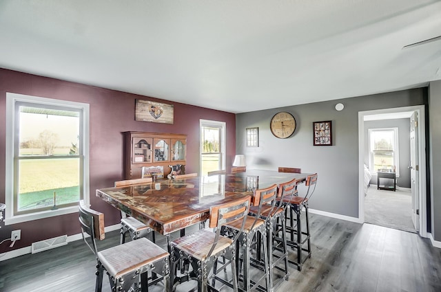 dining area with dark hardwood / wood-style flooring