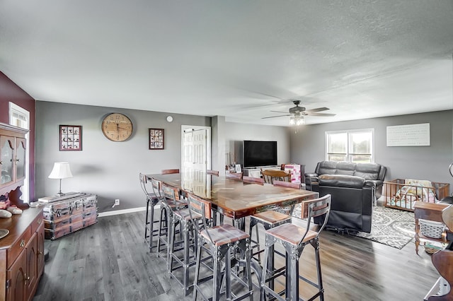 dining room with dark hardwood / wood-style flooring and ceiling fan