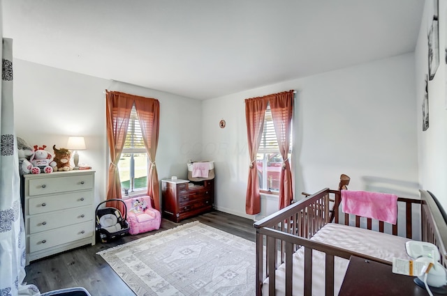 bedroom with dark hardwood / wood-style floors