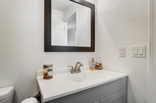 bathroom featuring vanity and toilet