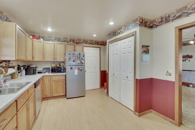 kitchen featuring light brown cabinets, a sink, light countertops, appliances with stainless steel finishes, and light wood-type flooring