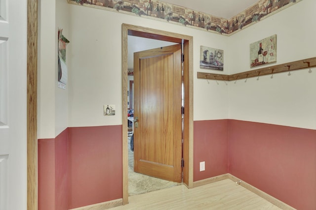 interior space with baseboards and wood finished floors