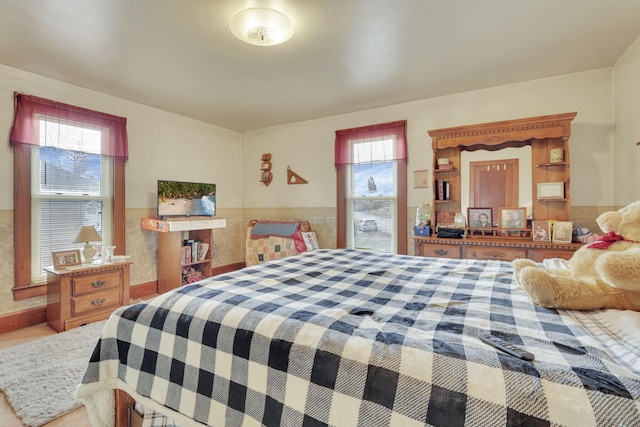 bedroom featuring a wainscoted wall