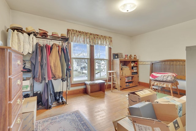 bedroom with baseboards and wood finished floors