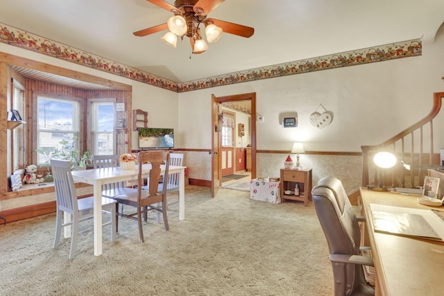 dining space featuring a ceiling fan, carpet flooring, plenty of natural light, and wallpapered walls