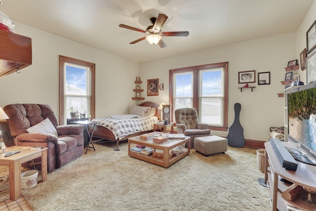 bedroom with ceiling fan and baseboards