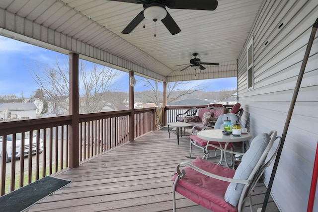 wooden terrace with a ceiling fan