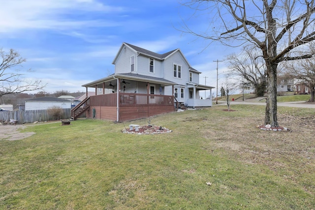 view of side of property with a lawn, ceiling fan, stairs, fence, and a deck