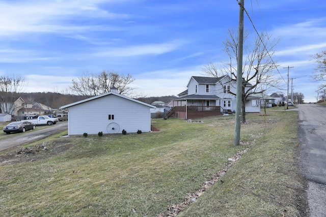 view of side of property with a residential view and a yard