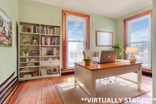 unfurnished office featuring wood finished floors