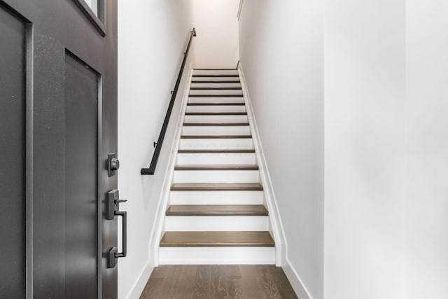 stairs featuring hardwood / wood-style flooring