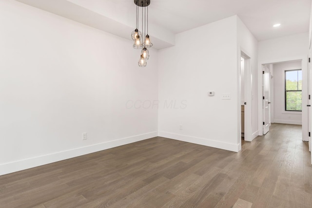 empty room with dark wood-type flooring