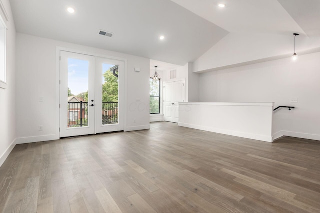 unfurnished living room with french doors, wood-type flooring, and lofted ceiling