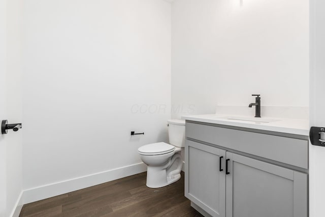 bathroom featuring hardwood / wood-style flooring, vanity, and toilet