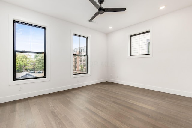 unfurnished room with hardwood / wood-style floors and ceiling fan