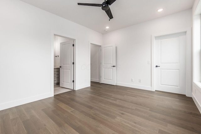 unfurnished bedroom with hardwood / wood-style floors, ceiling fan, and ensuite bath