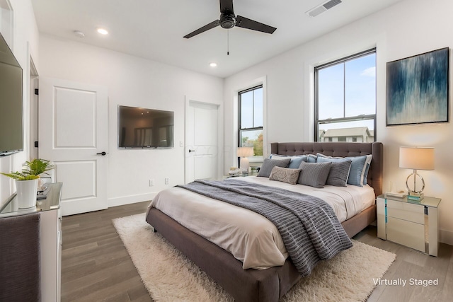 bedroom featuring dark hardwood / wood-style flooring and ceiling fan