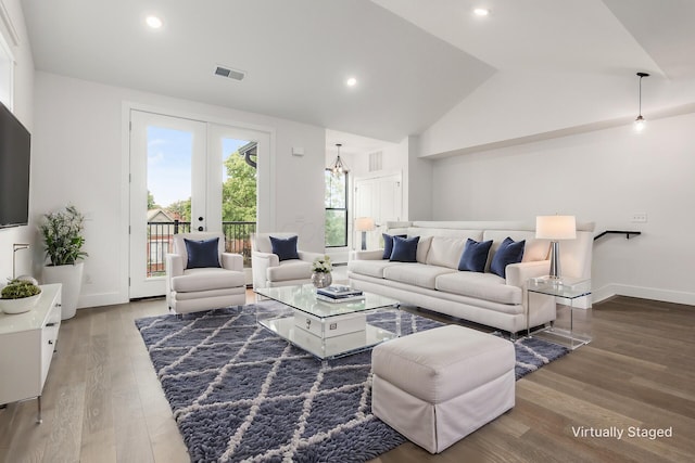 living room with french doors, wood-type flooring, and vaulted ceiling