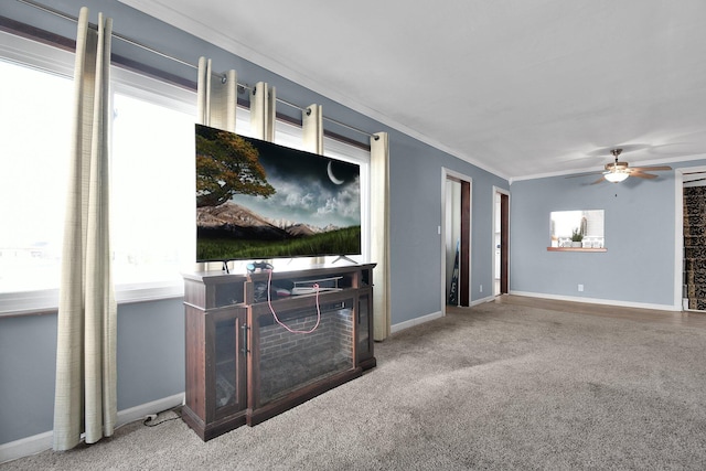 unfurnished living room with carpet, ceiling fan, and crown molding