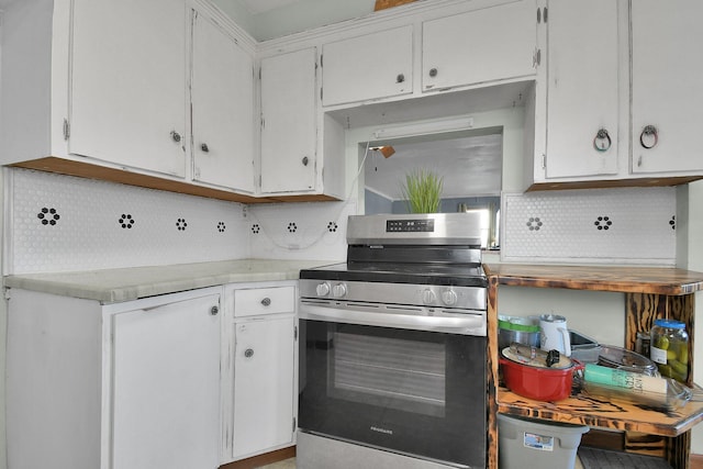 kitchen with white cabinetry, stainless steel range with gas cooktop, and backsplash