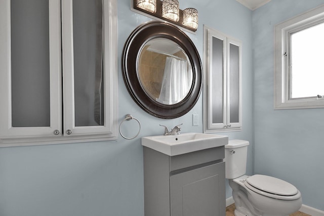 bathroom with vanity, toilet, and walk in shower