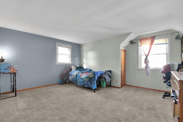 carpeted bedroom with lofted ceiling